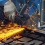 Construction worker using angle grinder